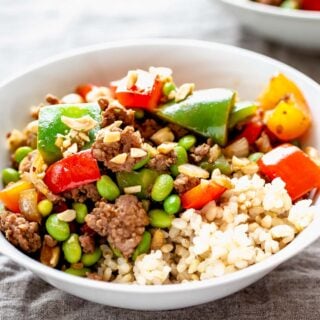 A bowl of food on a plate, with Pork