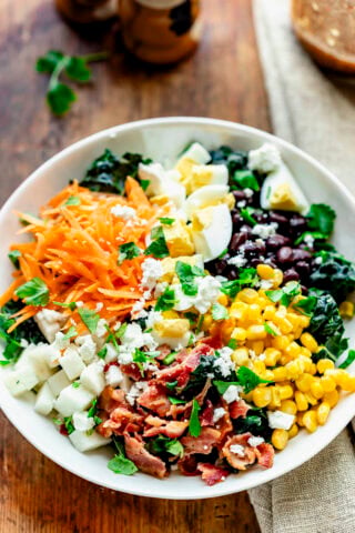 the salad from an mostly overhead angle where the ingredients are all separated into sections in an esthetically pleasing way