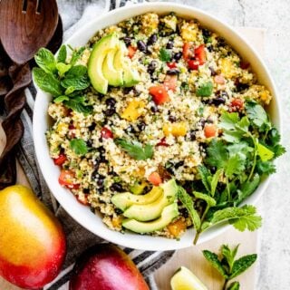 overhead table scape with the bowl of salad and two mangos