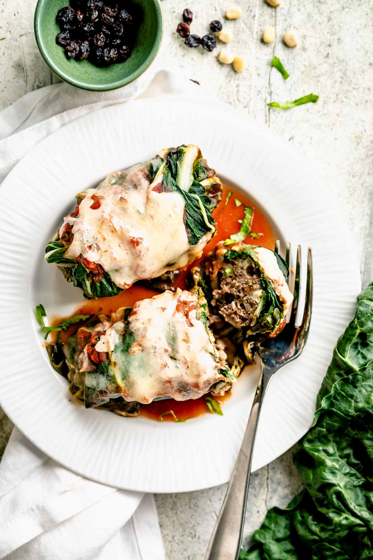 a plate with swiss chard rolls on it