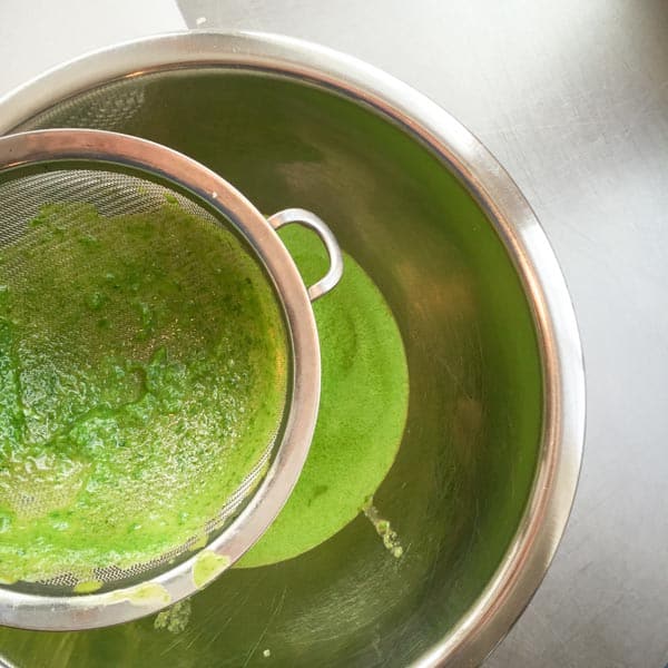 drain the chive oil through a fine mesh sieve to extract the chive solids