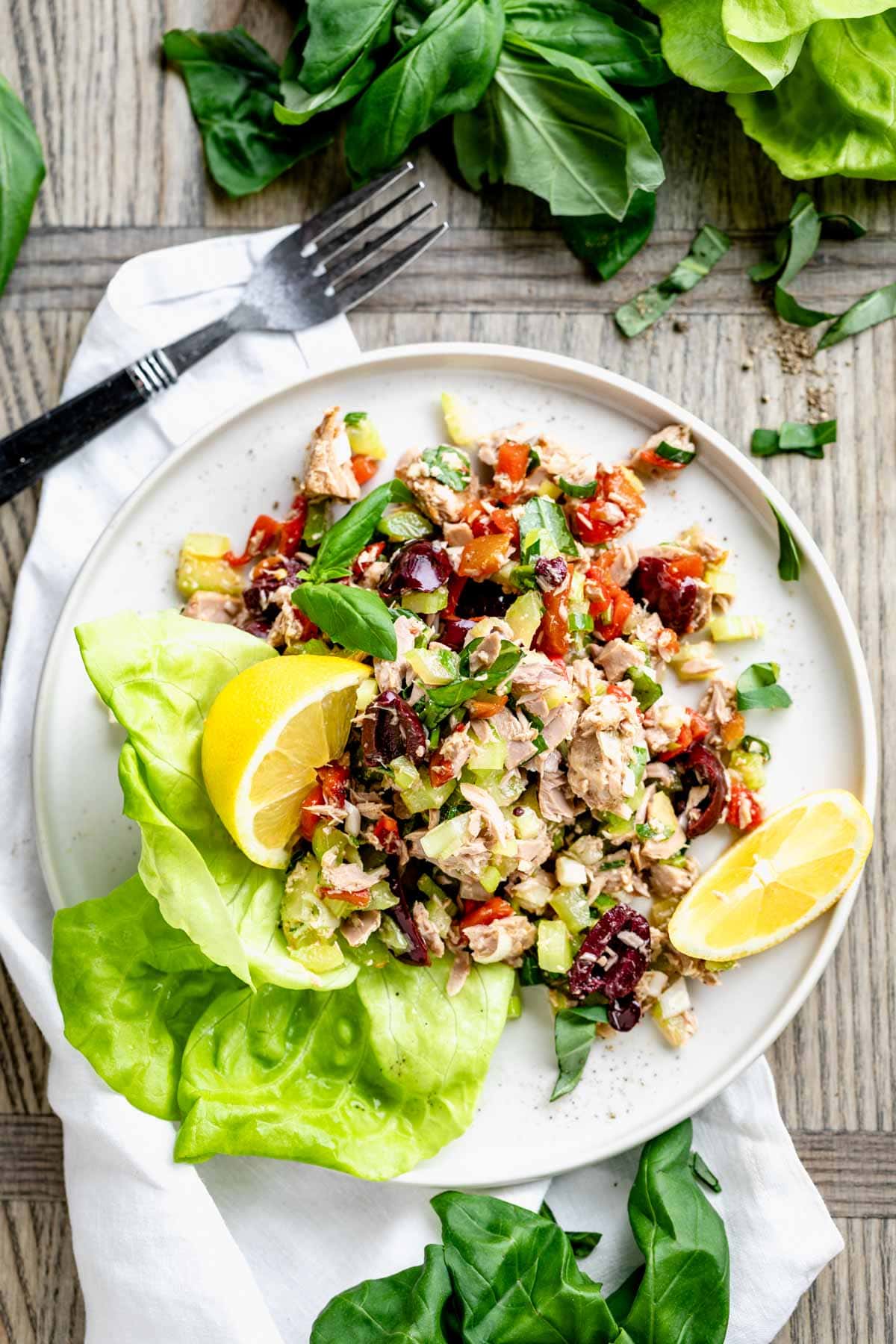 tuna on a plate with lemon wedges