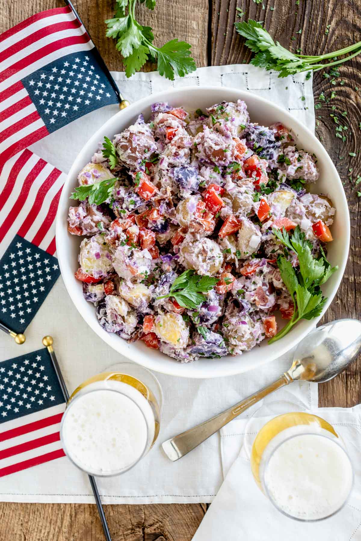 the potato salad on a picnic table with flags and beer