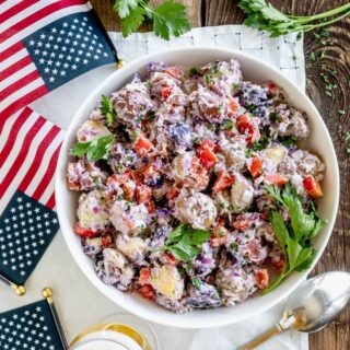 Red white and blue potato salad from overhead with flags on the table