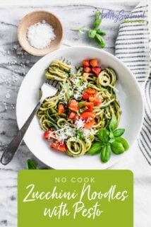 zucchini noodles with pesto in a bowl with a fork