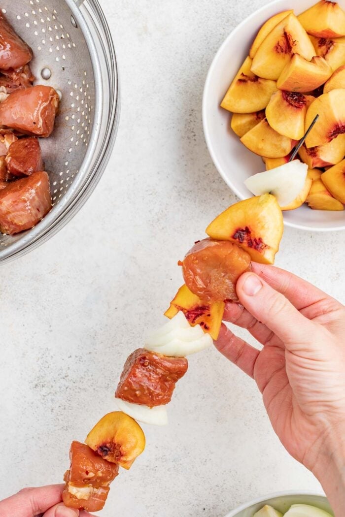 skewer the pork, peach and onions