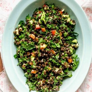 close up of lentil salad in a turquoise serving bowl