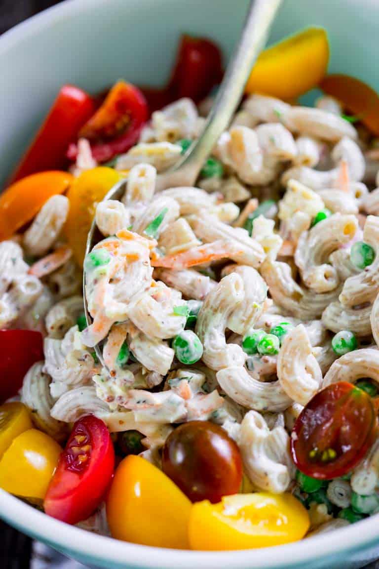 Healthy macaroni salad with tomatoes in a bowl