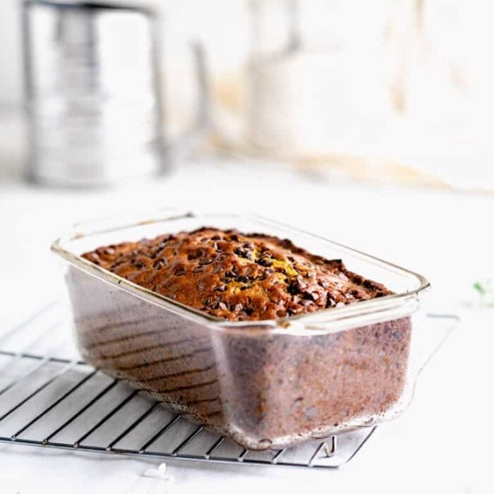 a glass loaf pan with Zucchini Bread in it