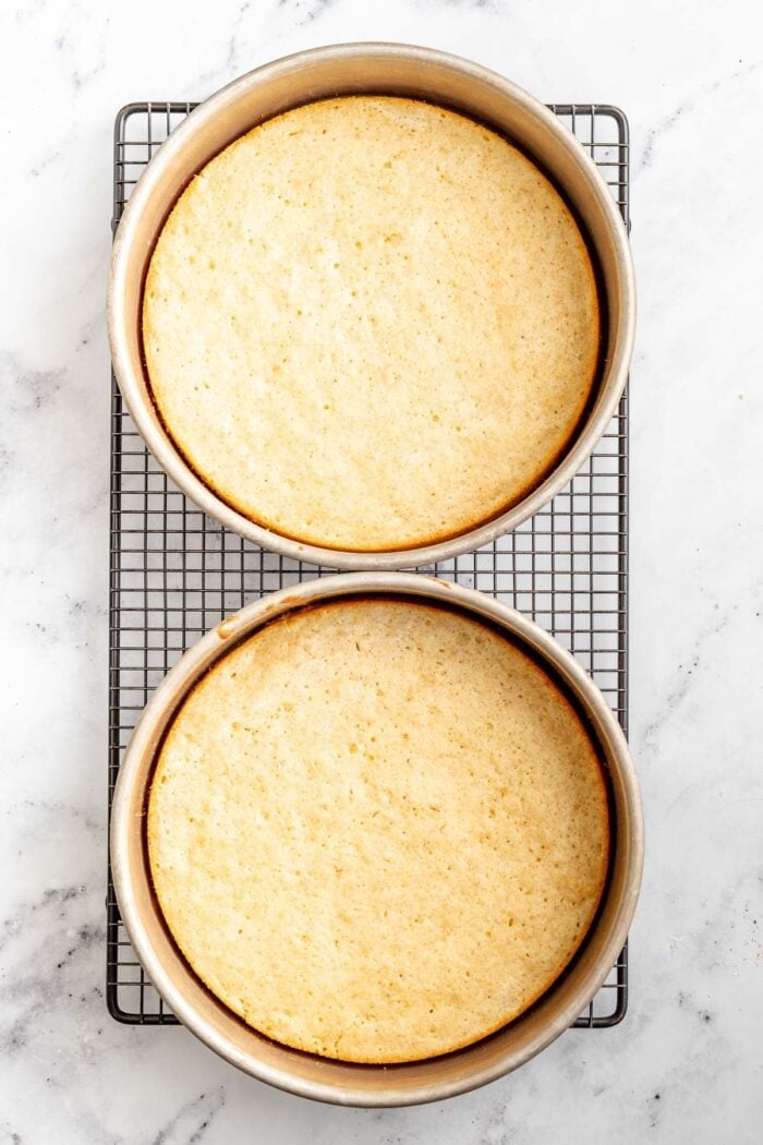 the finished layers on the cooling rack in the cake pans