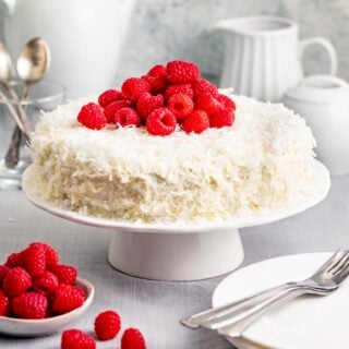 close up of the whole cake with raspberries on top
