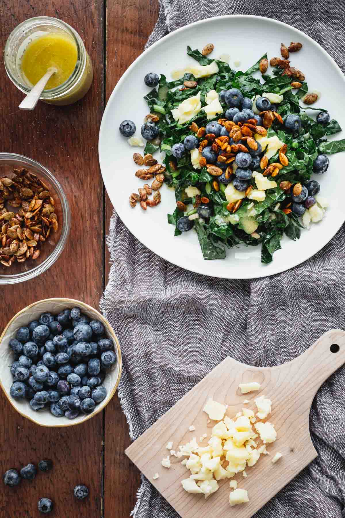 a plate of salad with the mise en place around it