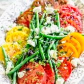 tomatoes, green beans and goat cheese on a large oval platter