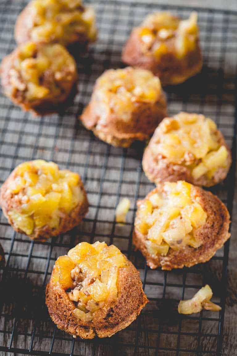 Kid friendly upside-down apple muffins placed on a rack to cool.