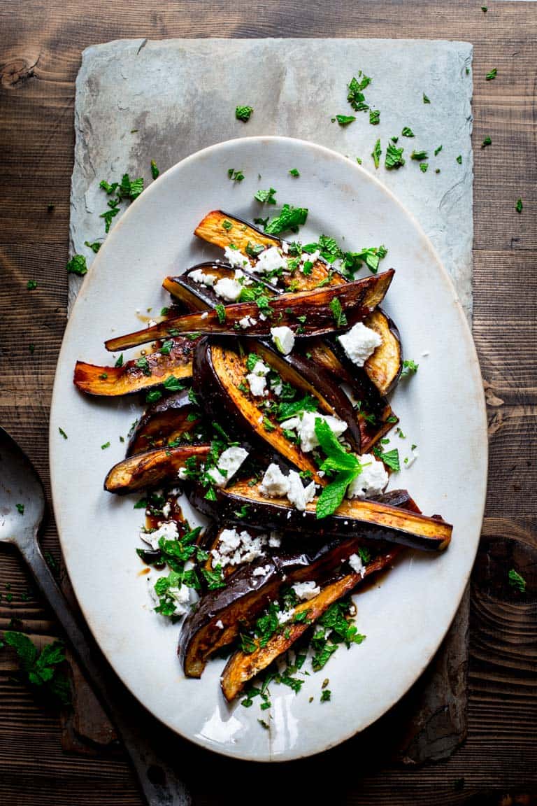 Eggplant with Pomegranate Molasses with mint on a serving plate