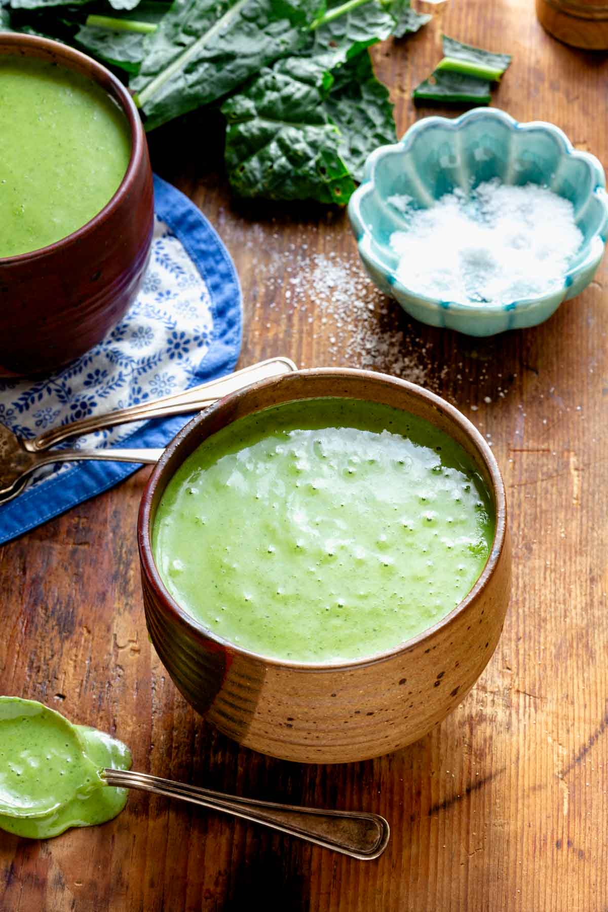 two bowls of soup with an aqua bowl dish of kosher salt