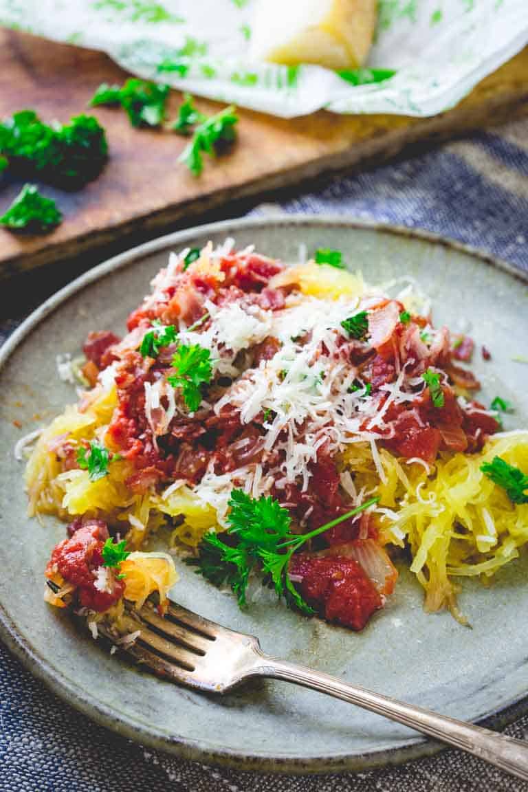 a plate of spaghetti squash with red sauce and cheese