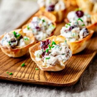 close-up of the phyllo cups with chicken salad on a wooden platter