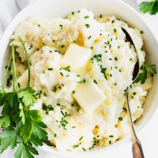 A plate of Potato with butter on top