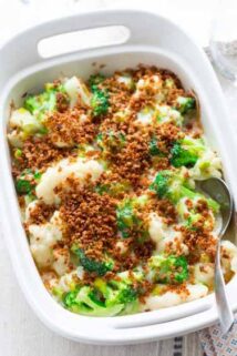 a white casserole dish with broccoli and cauliflower casserole with browned breadcrumbs on top