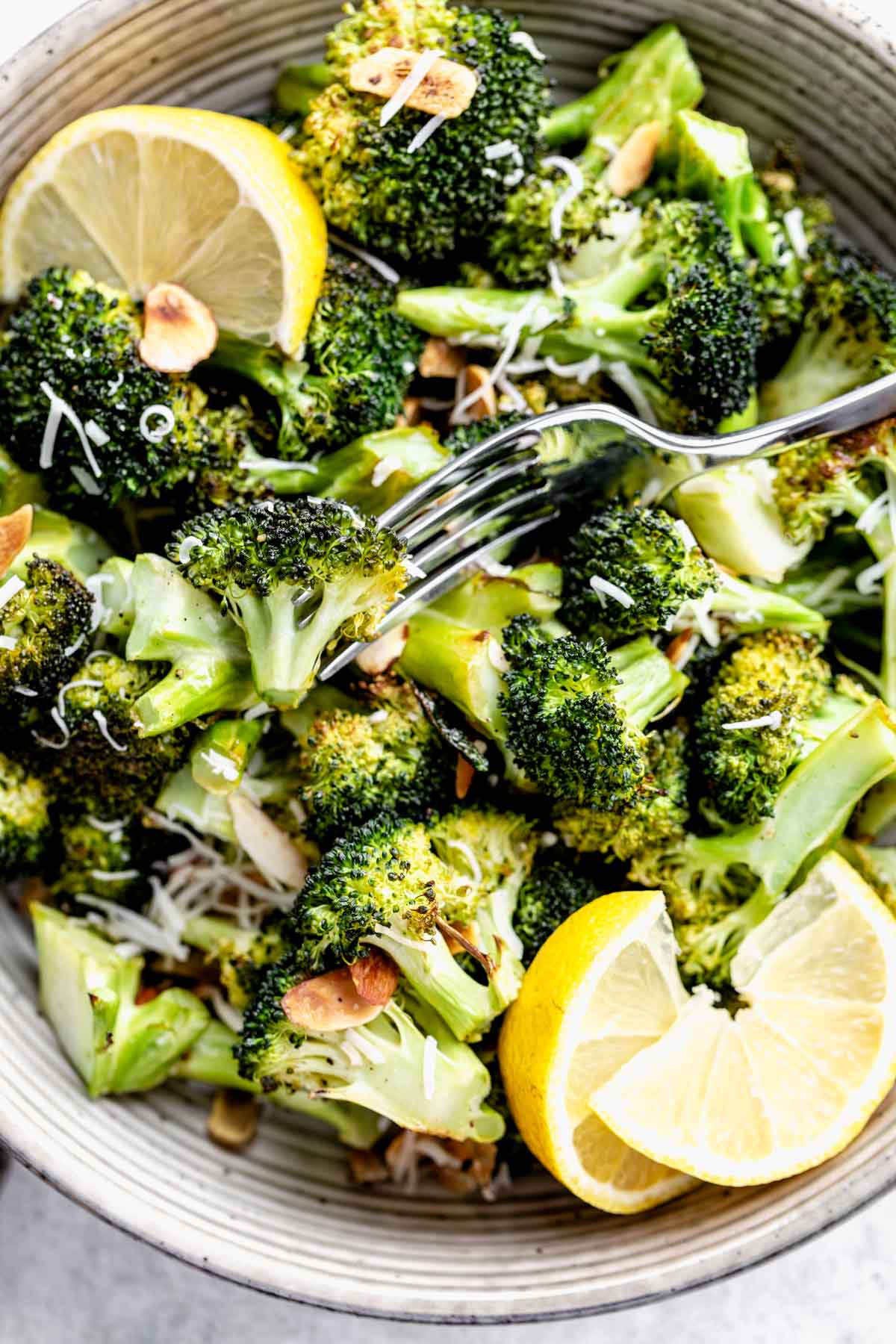 overhead shot of roasted broccoli in circular white bowl
