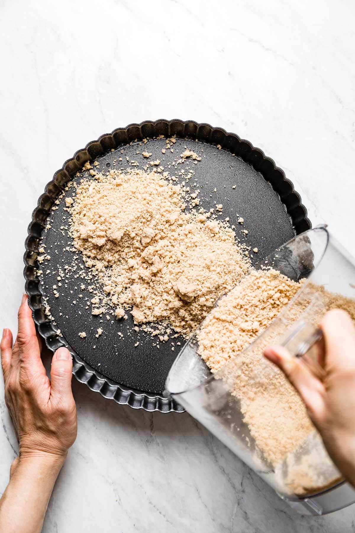 emptying the crust into the tart pan