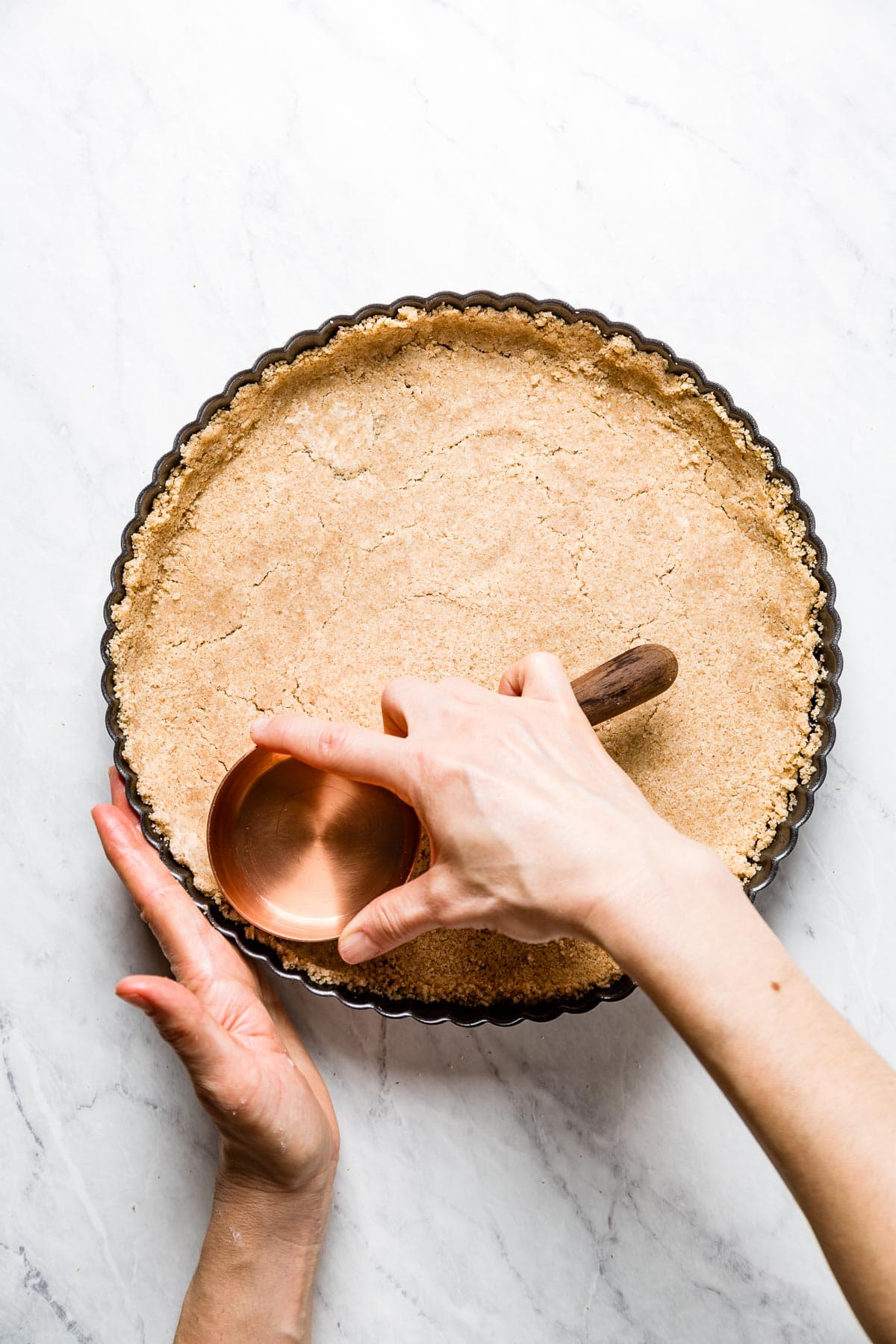 pressing the tart shell dough into place