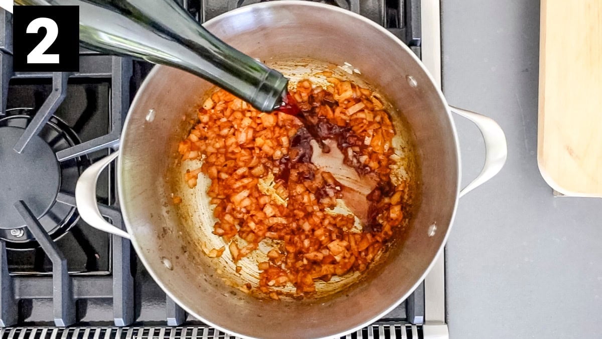 adding wine to the onion and spices