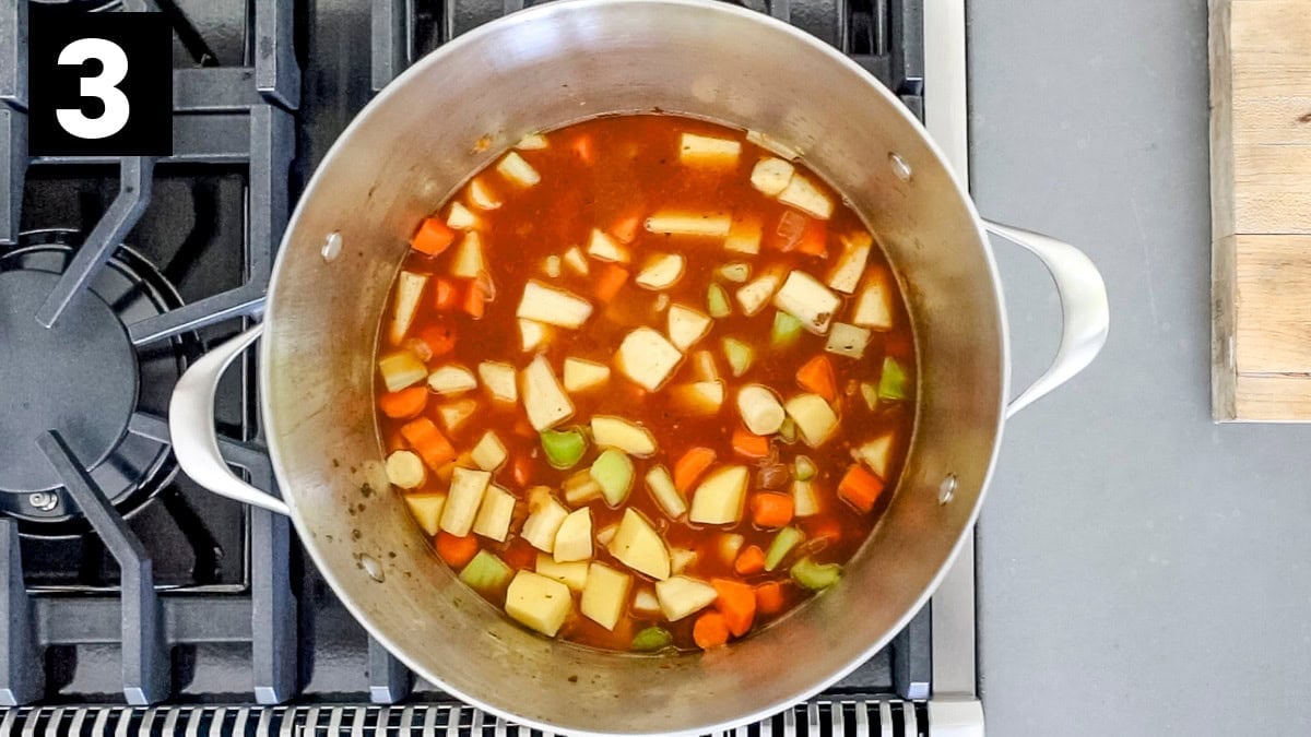 the pot with the broth and veggies added