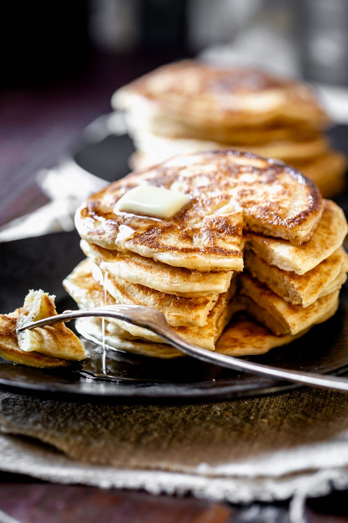 a stack of pancakes with a bite cut out
