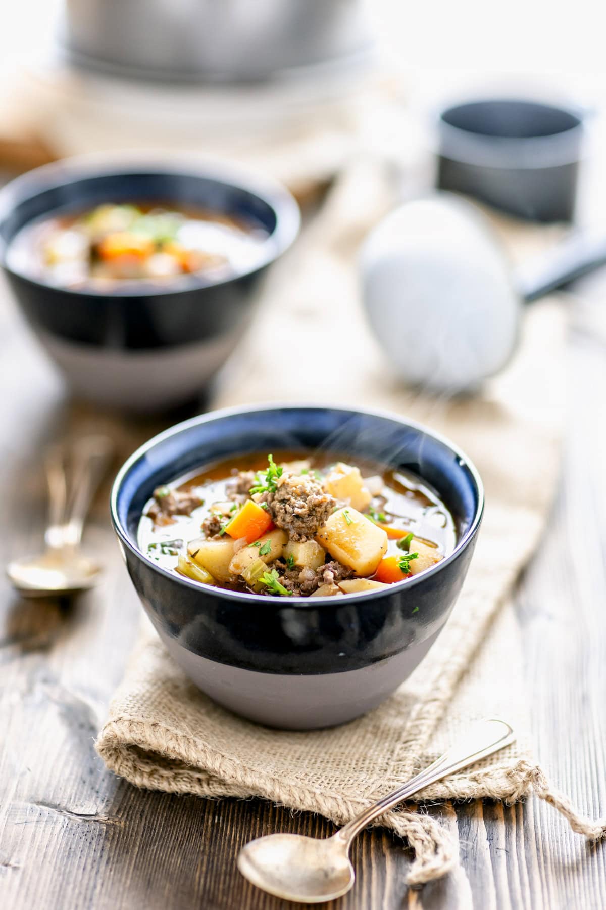 two steaming bowls of the hamburger stew