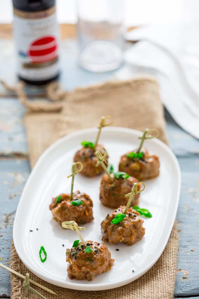 tamari turkey meatballs with maple tahini glaze on a serving platter with toothpicks