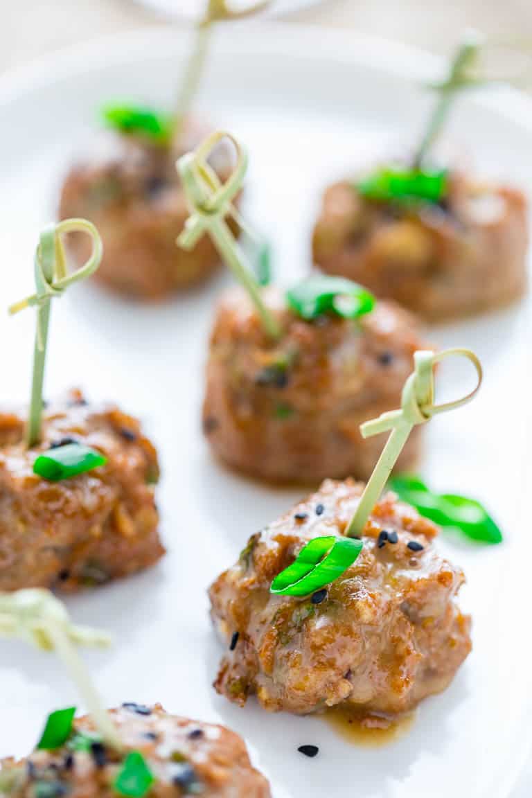 tamari turkey meatballs with maple tahini glaze on a serving platter with toothpicks