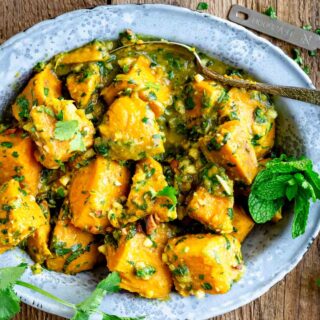 a metal dish with sweet potato curry