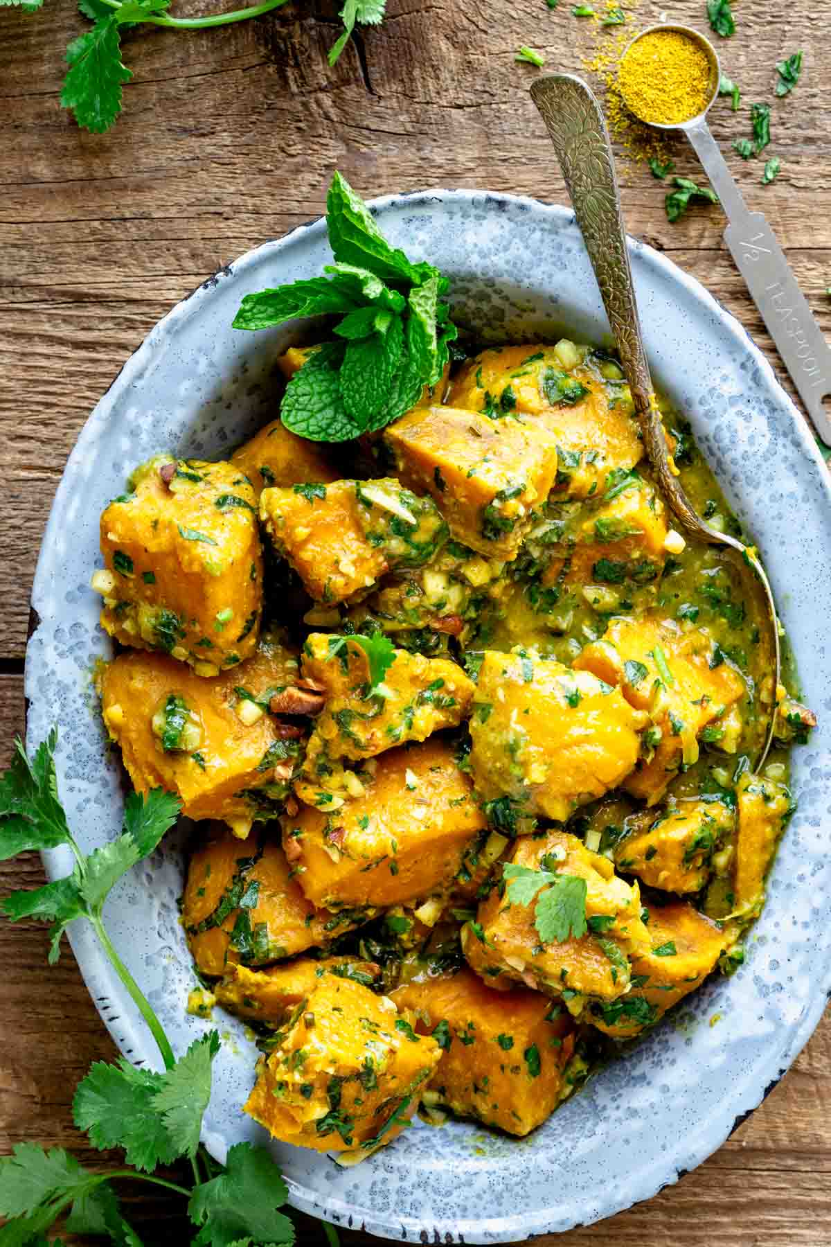 a metal dish with sweet potato curry