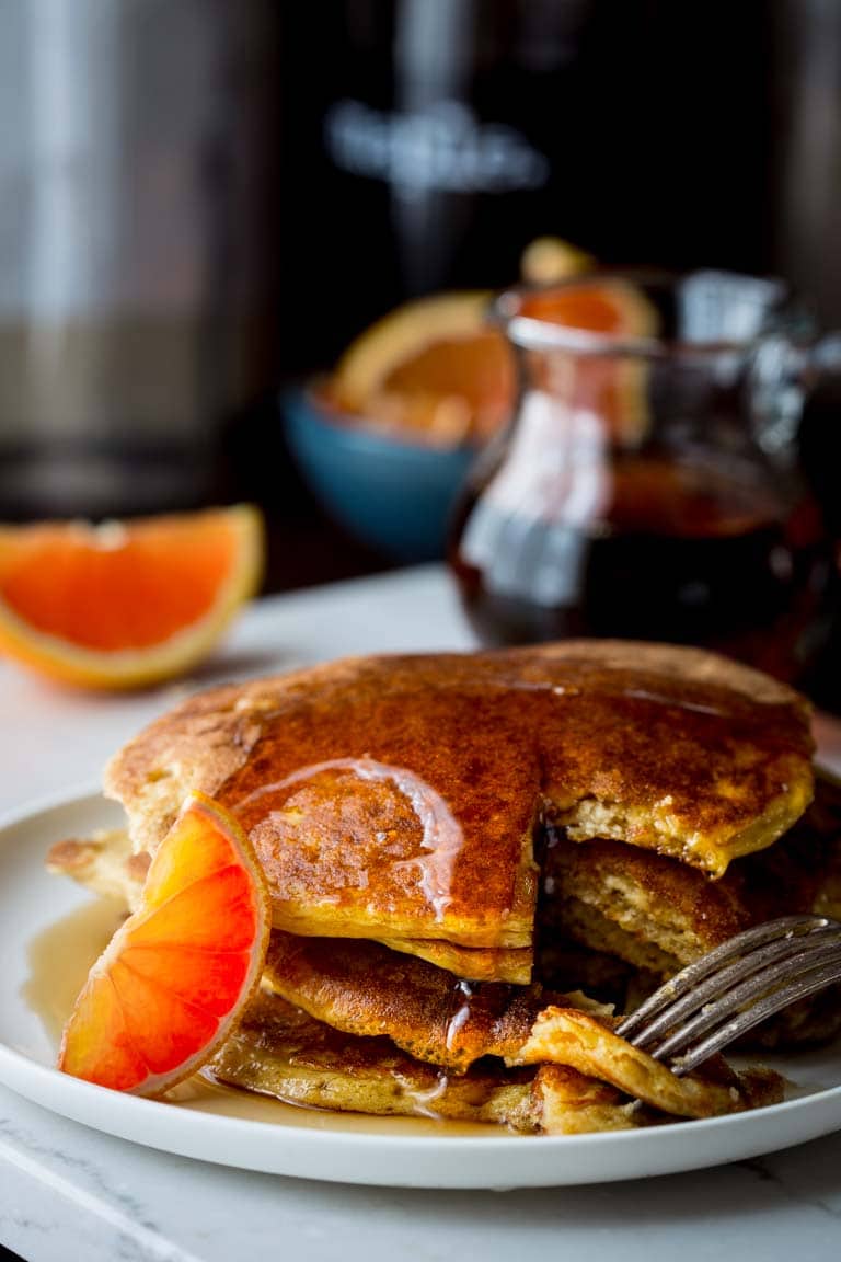 gluten-free Orange Protein Pancakes on a plate with maple syrup