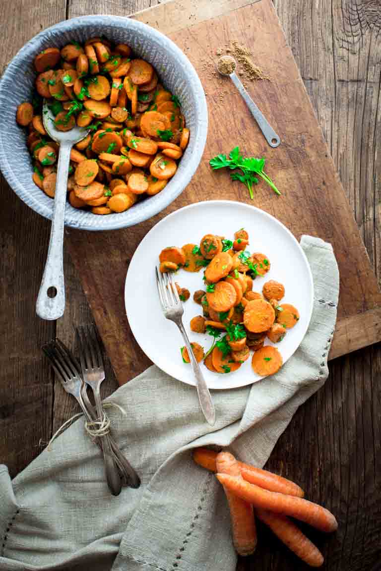 Spicy Moroccan Carrots in a serving bowl and on a plate
