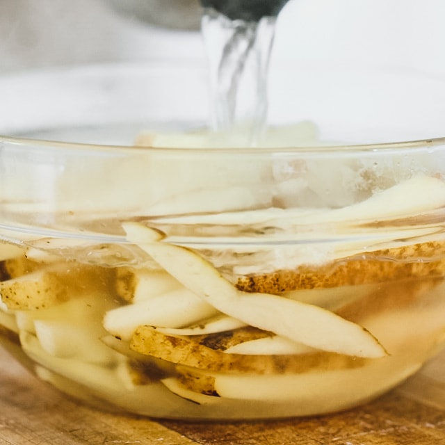 the potatoes in a bowl with hot water on them