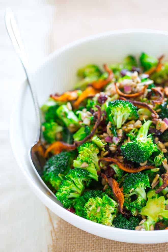 white bowl with raw broccoli salad in it