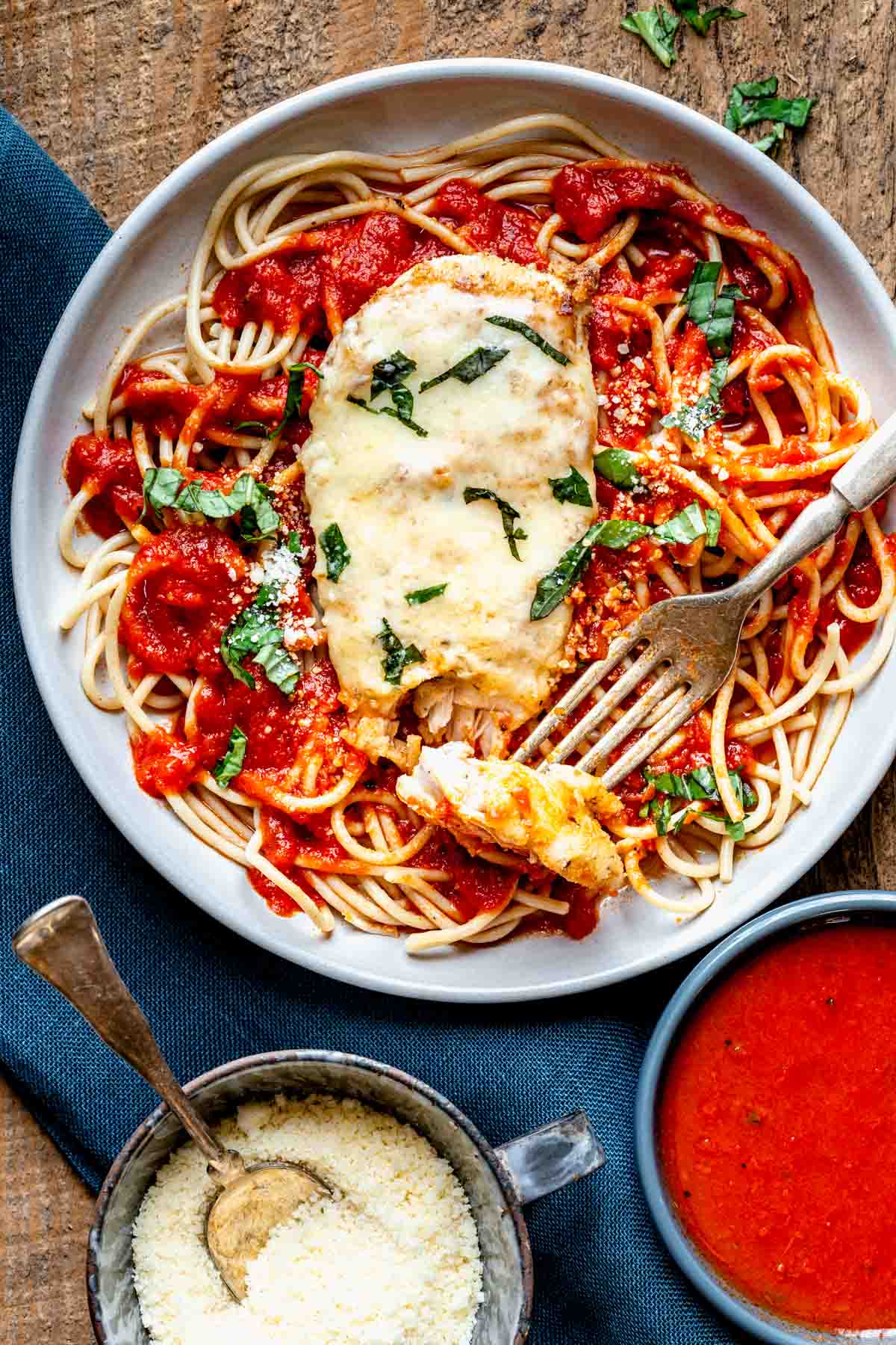 the chicken parmesan on a plate of spaghetti