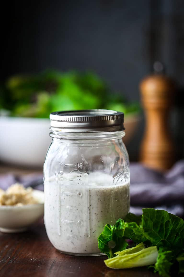Ranch Salad Dressing in a mason jar next to salad ingredients 
