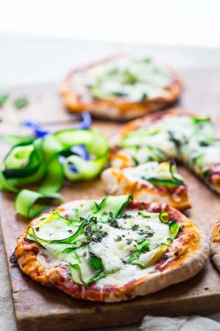 These 20 minute Zucchini Ribbon Pita Pizzas are a super fast, vegetarian weeknight meal that is also kid friendly. They will be making a regular rotation throughout zucchini season! | Healthy Seasonal Recipes | Katie Webster