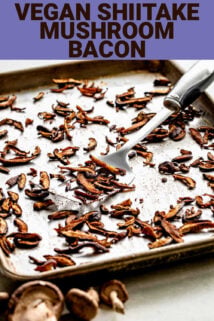 Shiitake mushroom bacon on a baking tray with.a spatula lifting up some of the pieces.