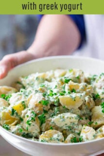 potato salad with herbs in white bowl text overlay