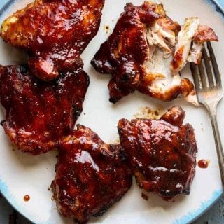 chicken thighs on a plate with a fork