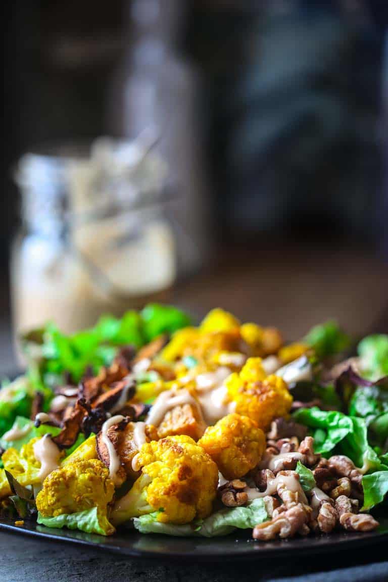 Turmeric Roasted Cauliflower and Tempeh Power Salad on a black plate