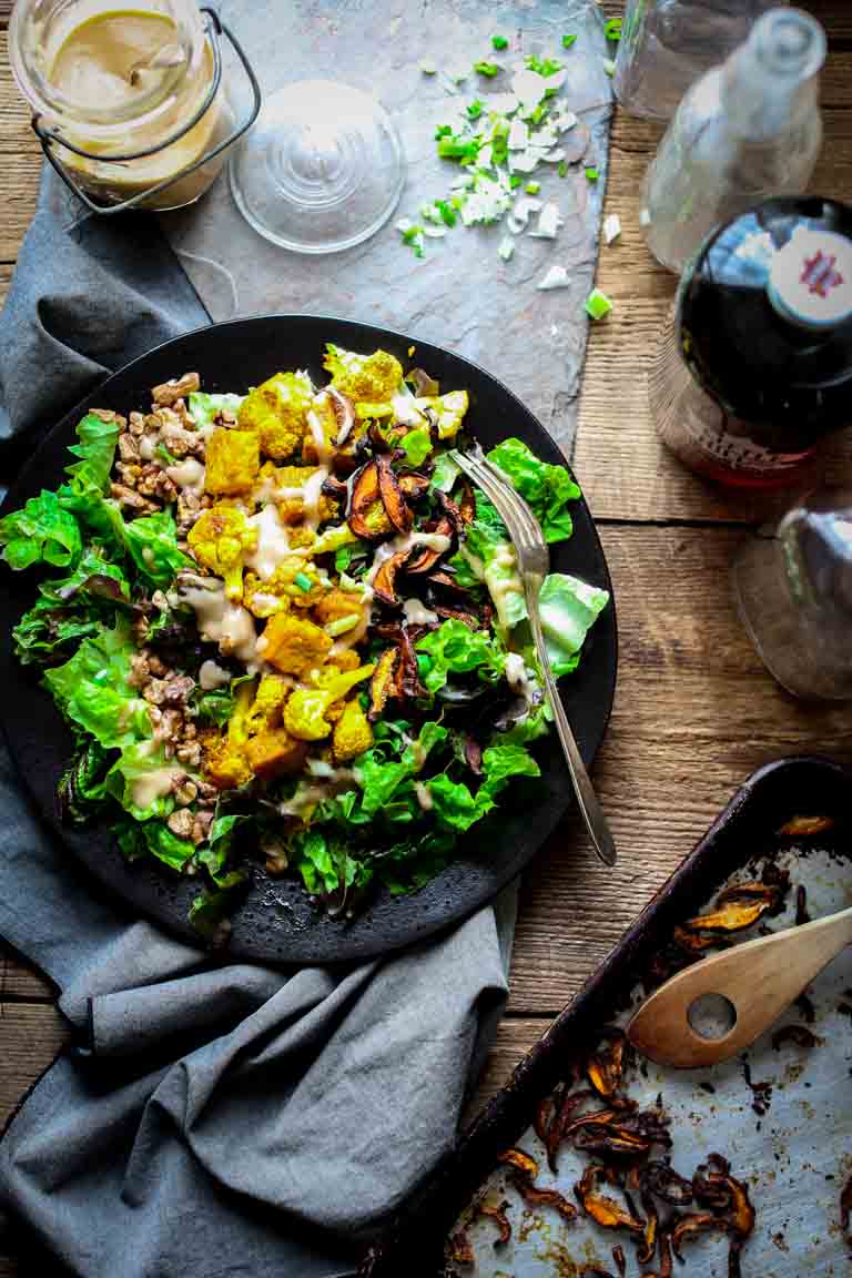 overhead photo of a plate of salad beside various jars and ingredients