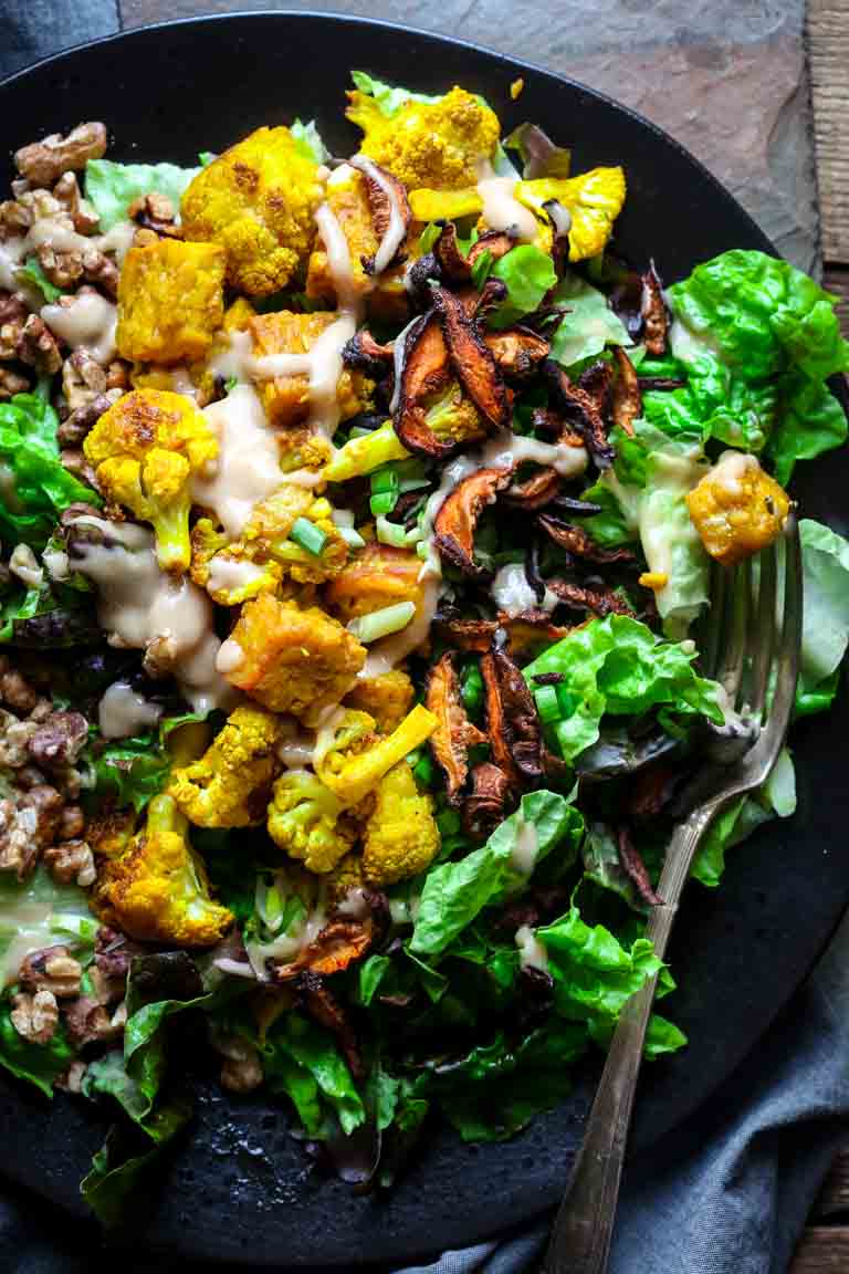 tempeh salad on a plate with a fork in it