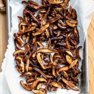 Shiitake mushroom bacon on baking paper on a tray.