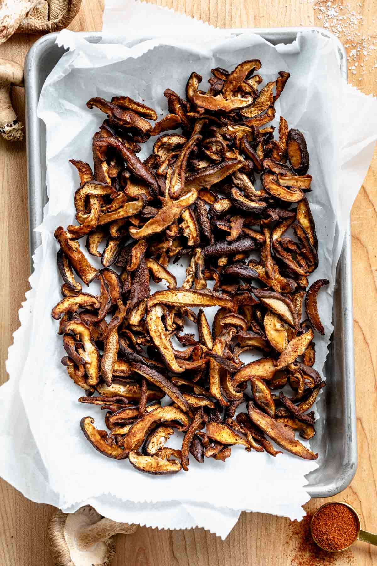Shiitake mushroom bacon on baking paper on a tray.